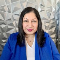 Headshot of Niketa Patel wearing a bright blue blazer