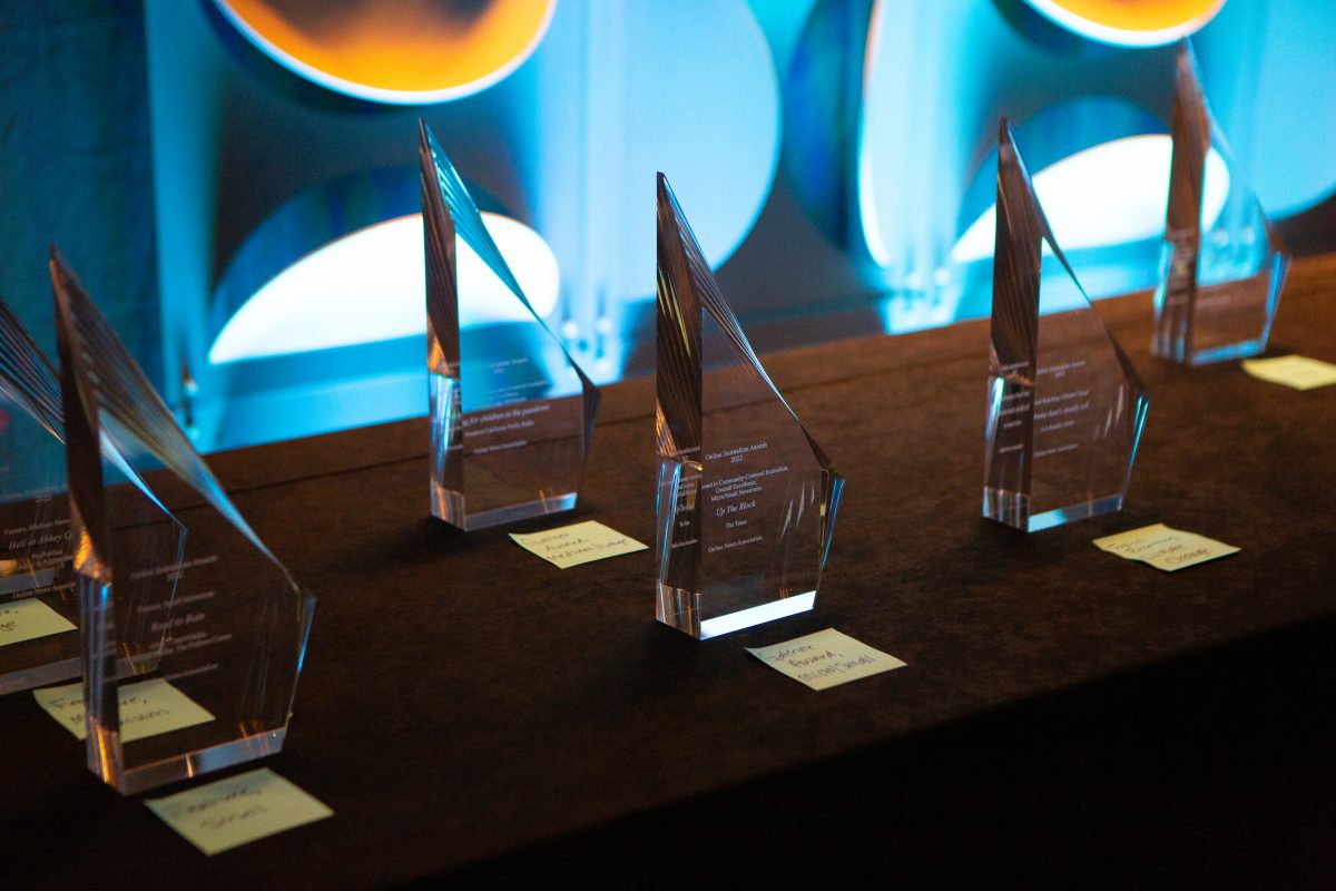 A series of Online Journalism Awards trophies sit on a table.