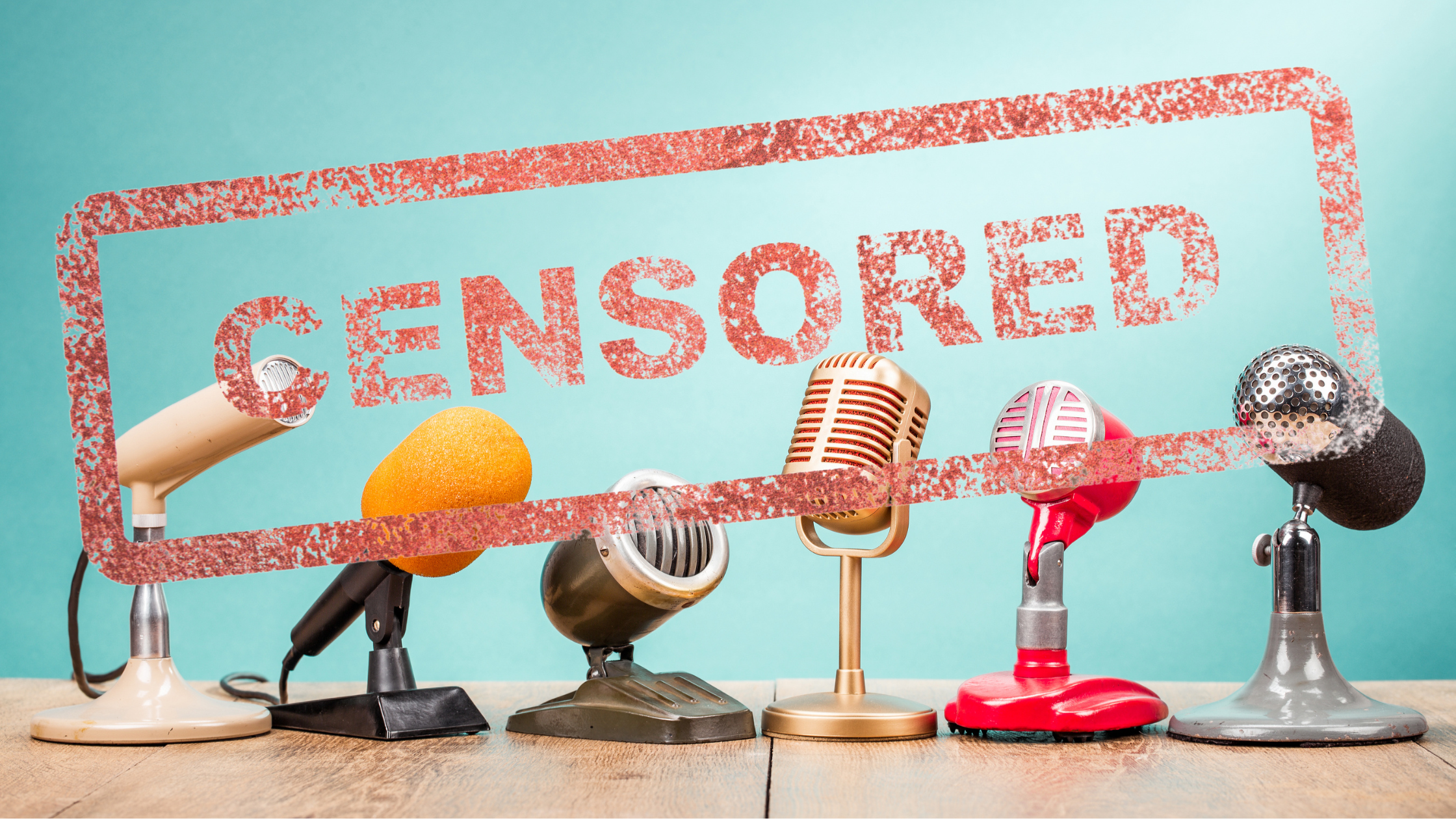 Six different types of microphones lined up on a table, with the word CENSORED overlaying the photo.